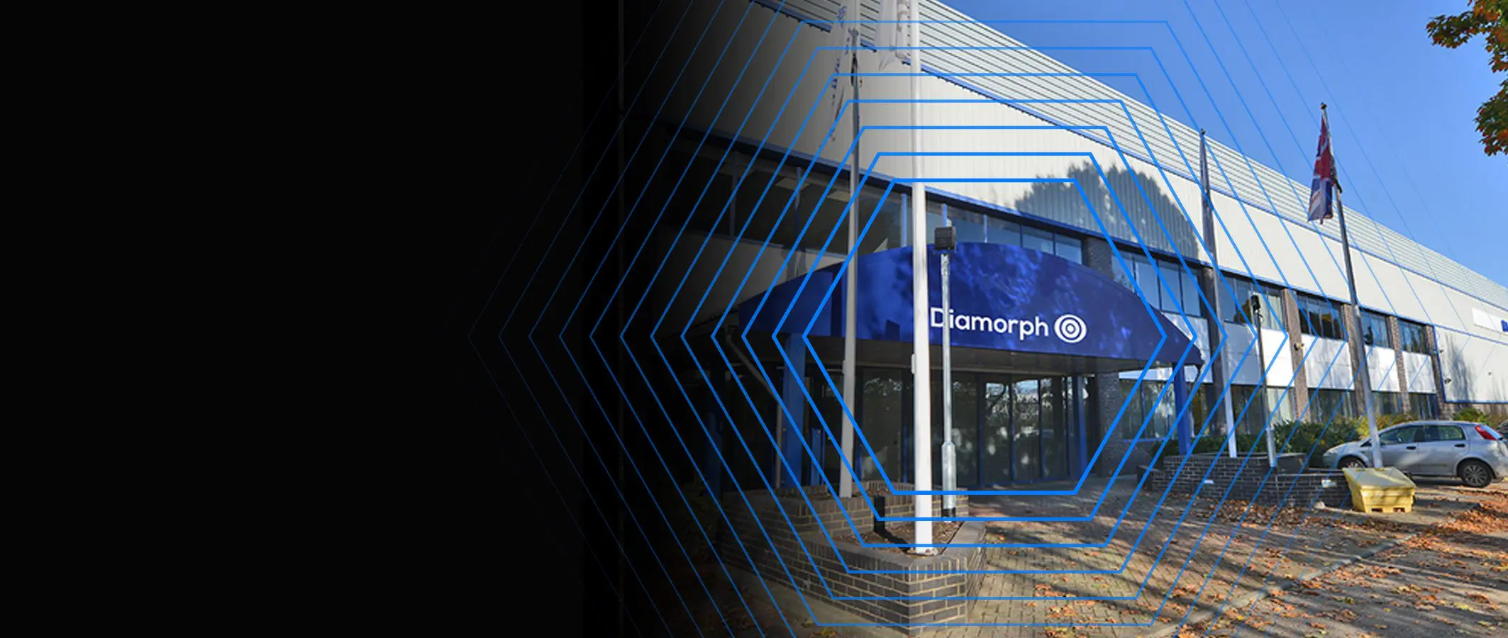 Entrance of a modern building with a blue awning labeled Amorph, surrounded by hexagonal blue graphics.