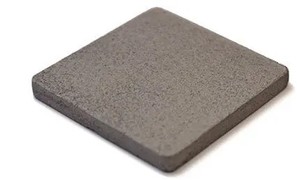 A single square, gray ceramic tile with rounded edges on a white background.