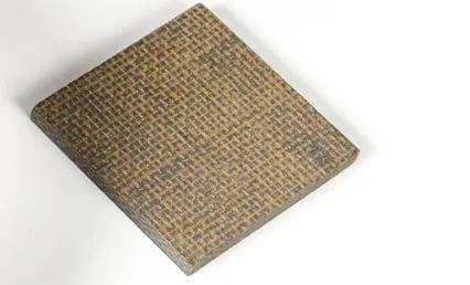 A textured, square piece of brown composite material on a white background.