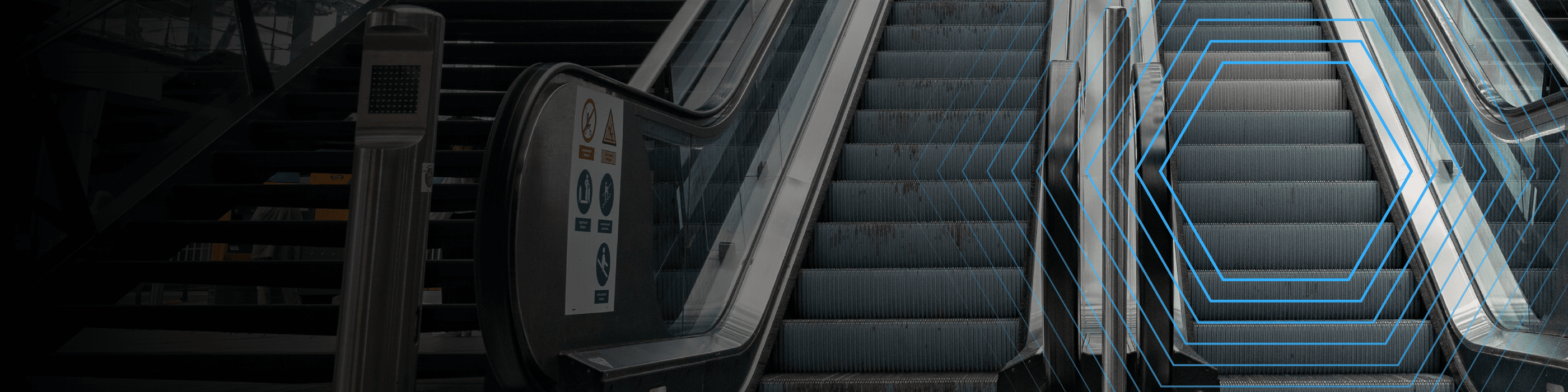 A close-up of two escalators, one going up and one going down, with blue hexagonal lines overlayed.