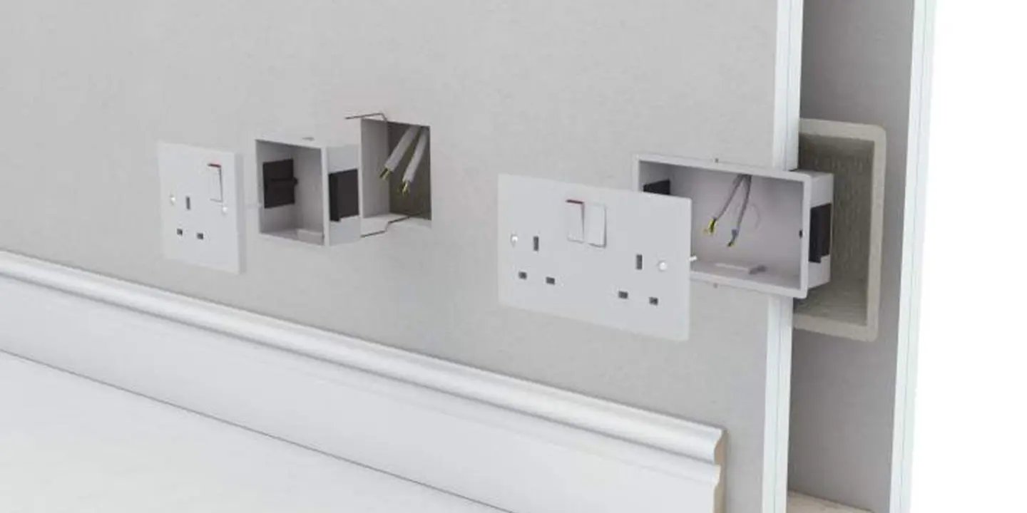 Three electrical wall sockets installed incorrectly, misaligned and partly outside the wall, exposing wires and boxes.