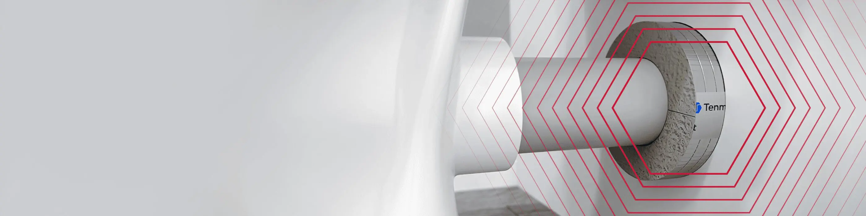 Close-up of a cylindrical device with red concentric lines and a partial label reading Tem.