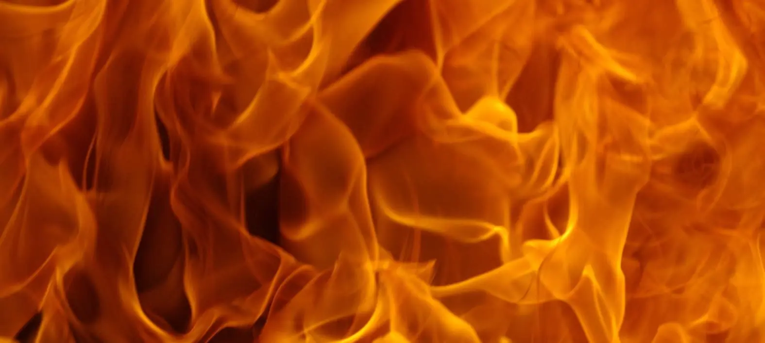 fire protection Intense orange and yellow flames swirl together in a vivid fire background.