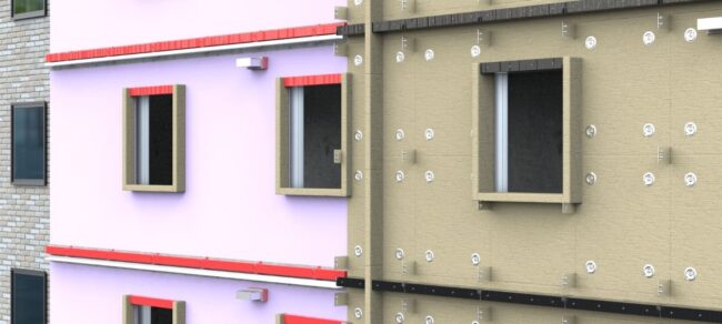 A building facade partially finished with insulation panels, exposing both bare and completed wall sections.